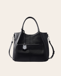 Carry leather tote bag in black, with a zip top, rolled handles and a slip pocket across the front