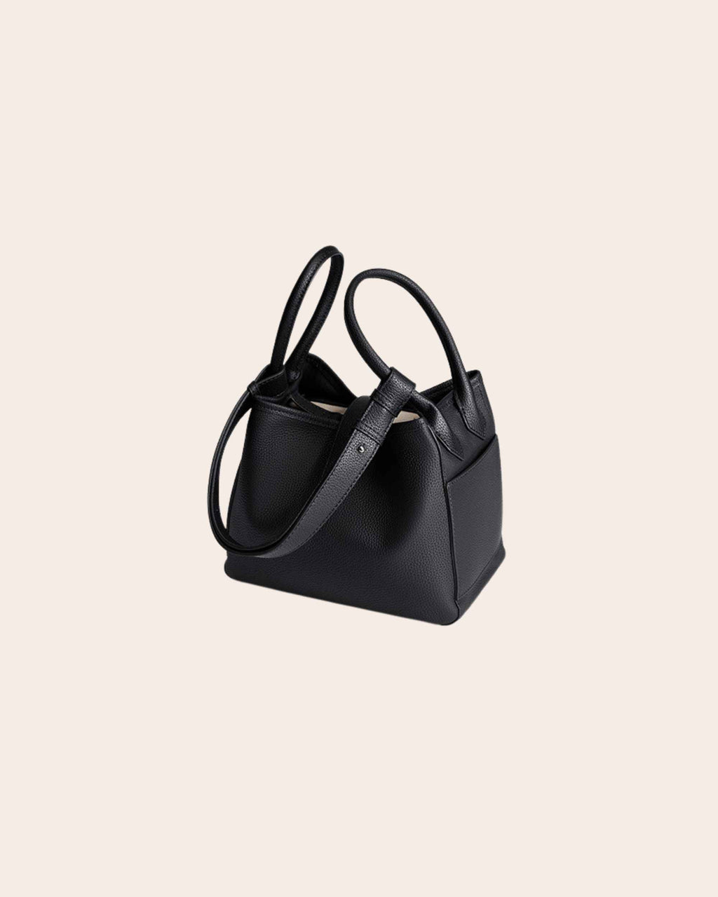 Haven pebbled leather basket bag in black, with a leather tab closure and a detachable strap