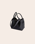 Haven pebbled leather basket bag in black, with a leather tab closure and a detachable strap