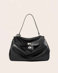Black soft leather flap bag with a silver turn lock and a top handle, shown from the front